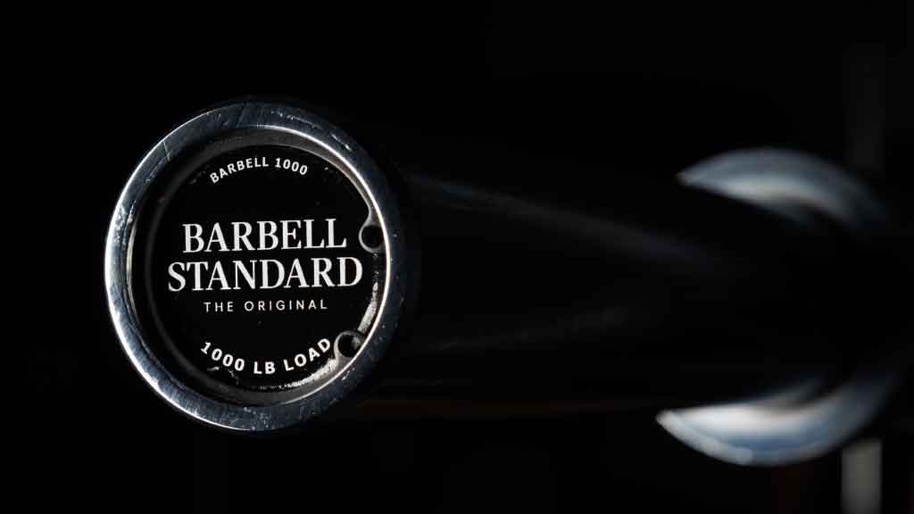 Barbell Standard 1000 training barbell with black end cap showing 1000 lb load capacity rating