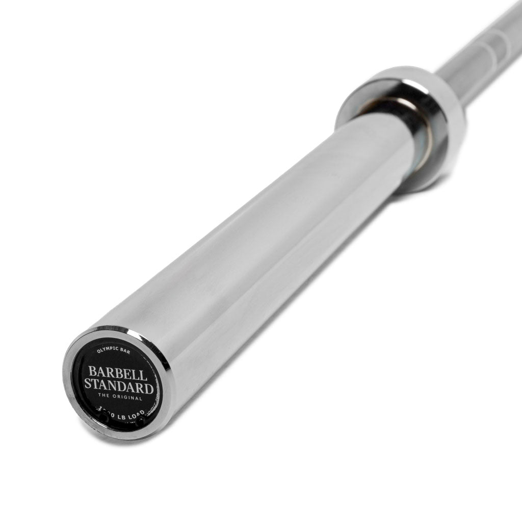 A silver Olympic barbell with the brand 'Barbell Standard' marked on the end.