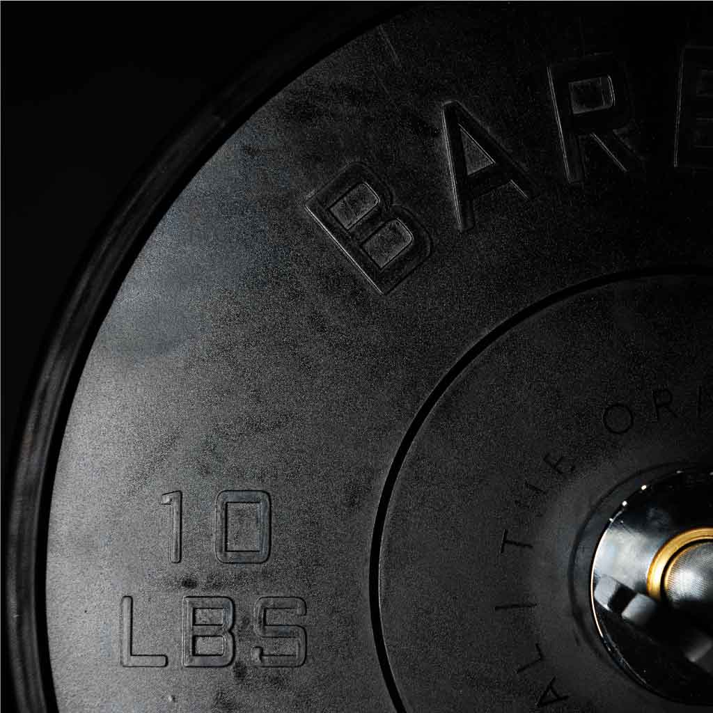 A set of black Olympic bumper plates with raised lettering and the Barbell Standard logo on the center.