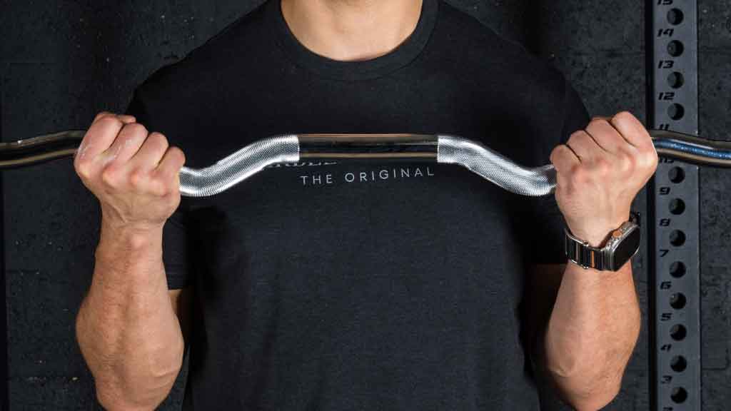 Athlete performing bicep curls with Barbell Standard EZ curl bar featuring knurled angled grip for comfort