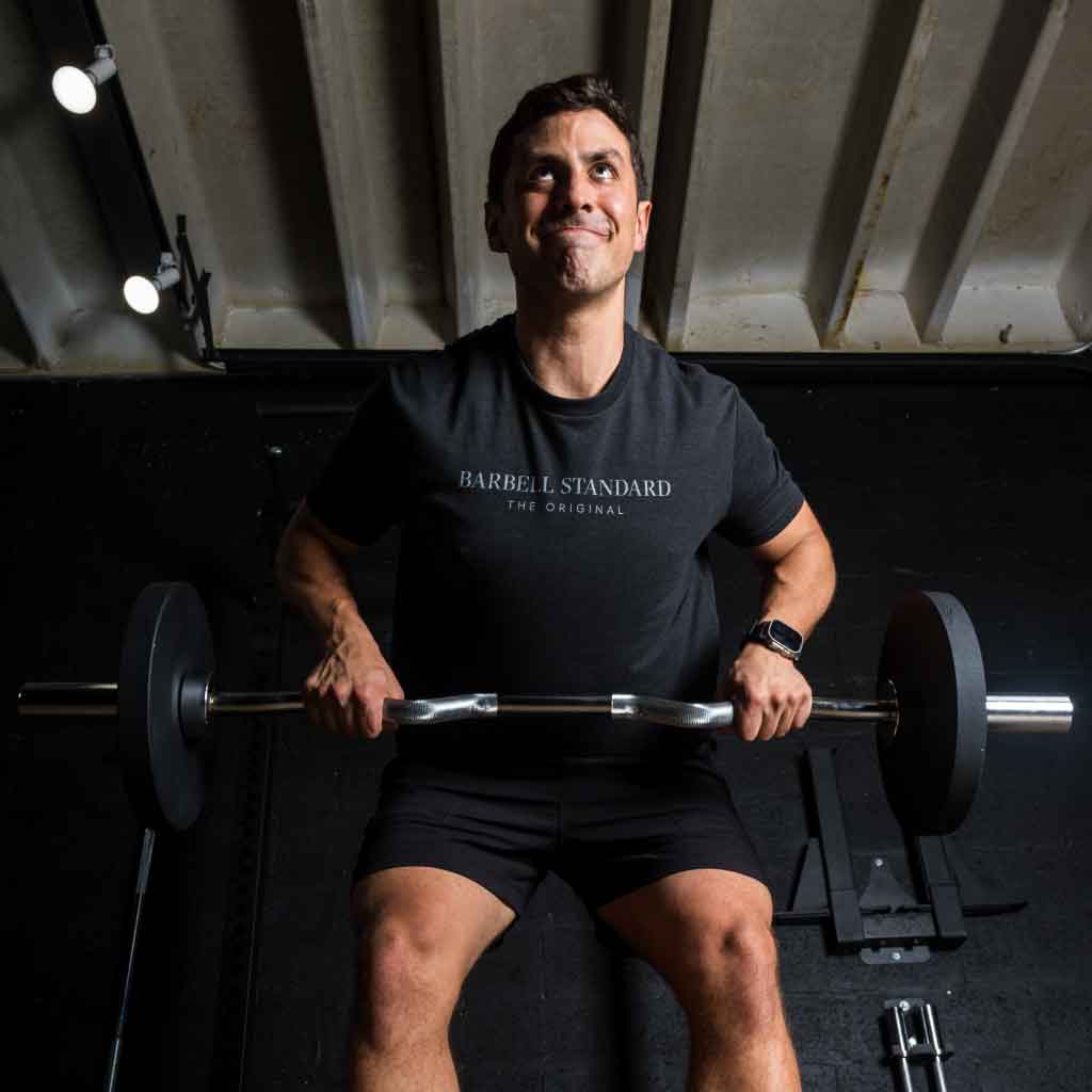 Athlete performing barbell row with Barbell Standard EZ curl bar in gym setting