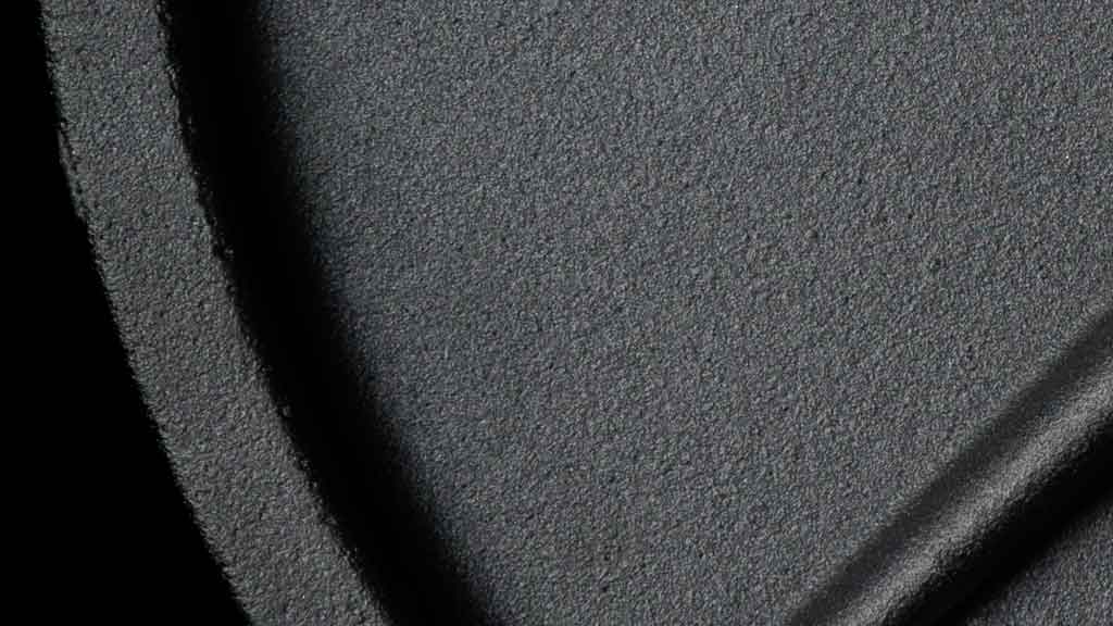 Close-up of deep lip edge on cast iron weight plate with black powder coat finish