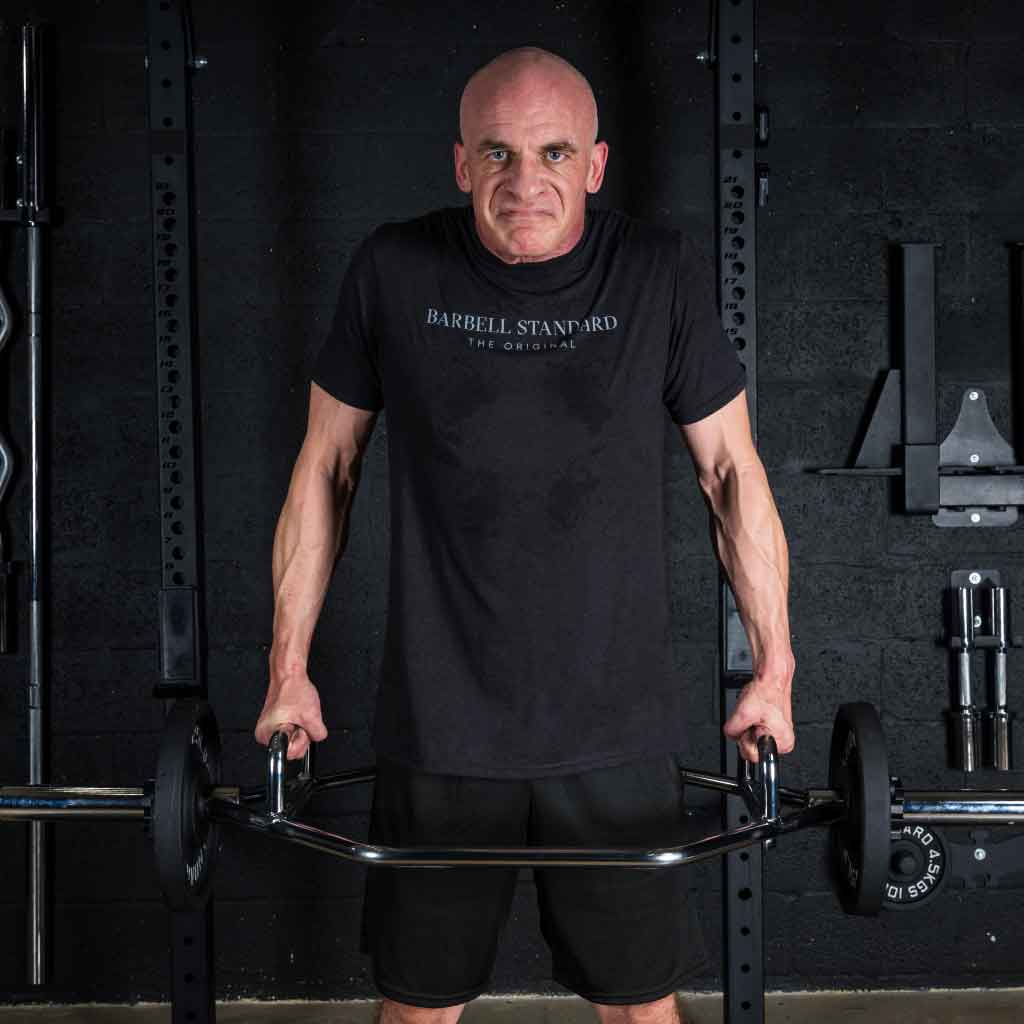 Man performing barbell shrugs with Barbell Standard hex trap bar in gym for strength training and muscle building