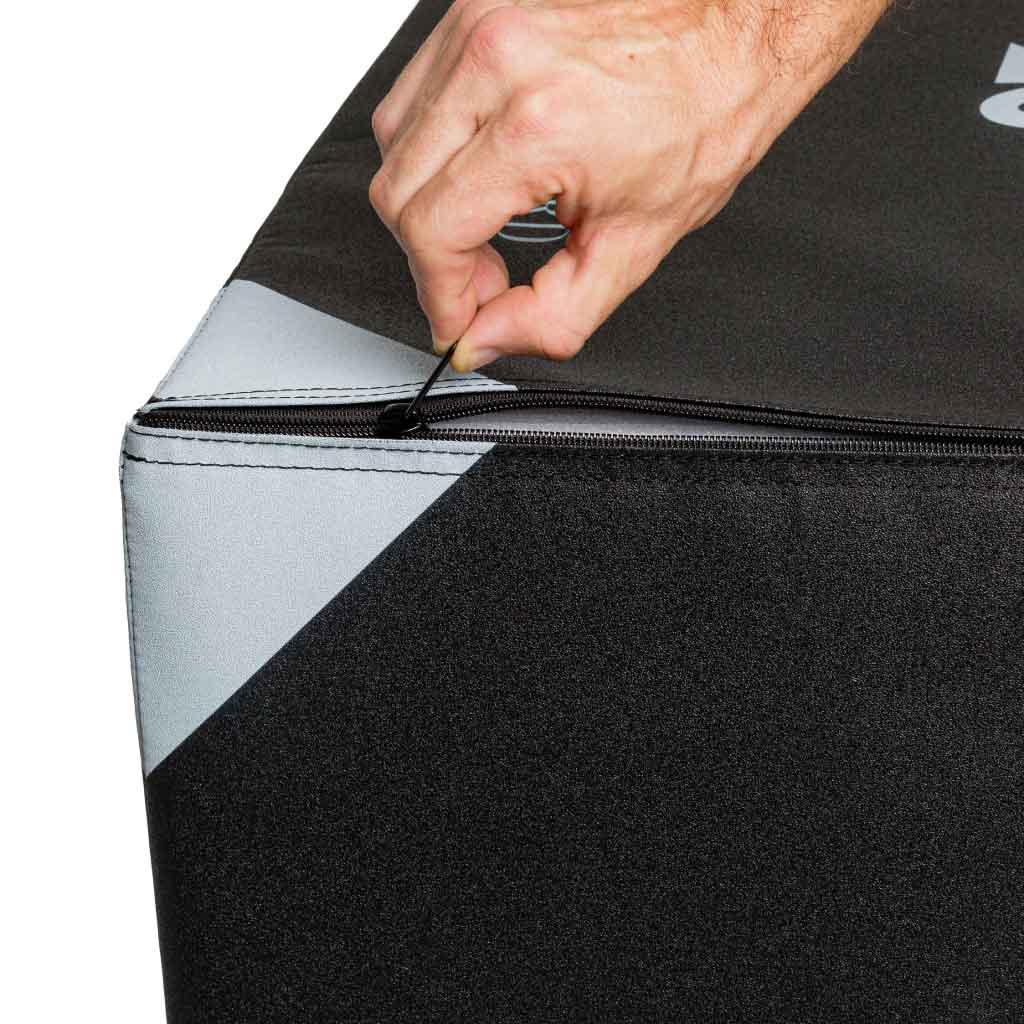Hand unzipping Barbell Standard foam plyo box cover, showing durable construction and removable outer layer for easy cleaning