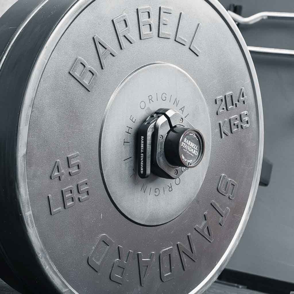 Close-up of Barbell Standard 45 lb weight plate with magnetic barbell collar securely attached