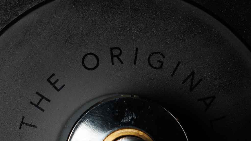 Close up of Barbell Standard bumper plate center hub with The Original text detail