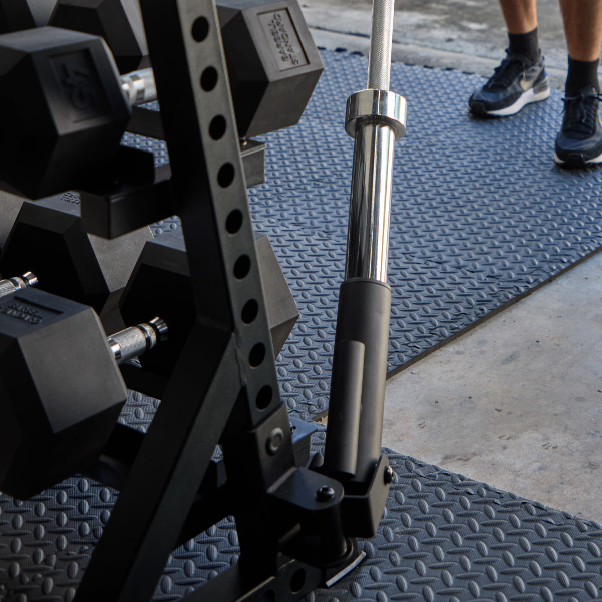 Barbell Standard Three-Tier Dumbbell Rack with hex dumbbells and barbell attachment in a gym