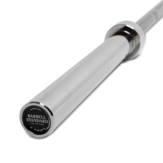 A silver Olympic barbell with the brand 'Barbell Standard' marked on the end.